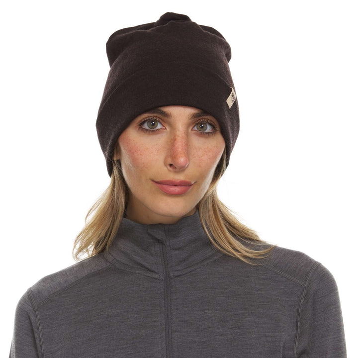 A woman models the lightweight, double-layered, hundred percent, super soft merino wool beanie perfect for fall, winter, and spring. This hat is perfect for a hike up the mountain or a walk around the block!

