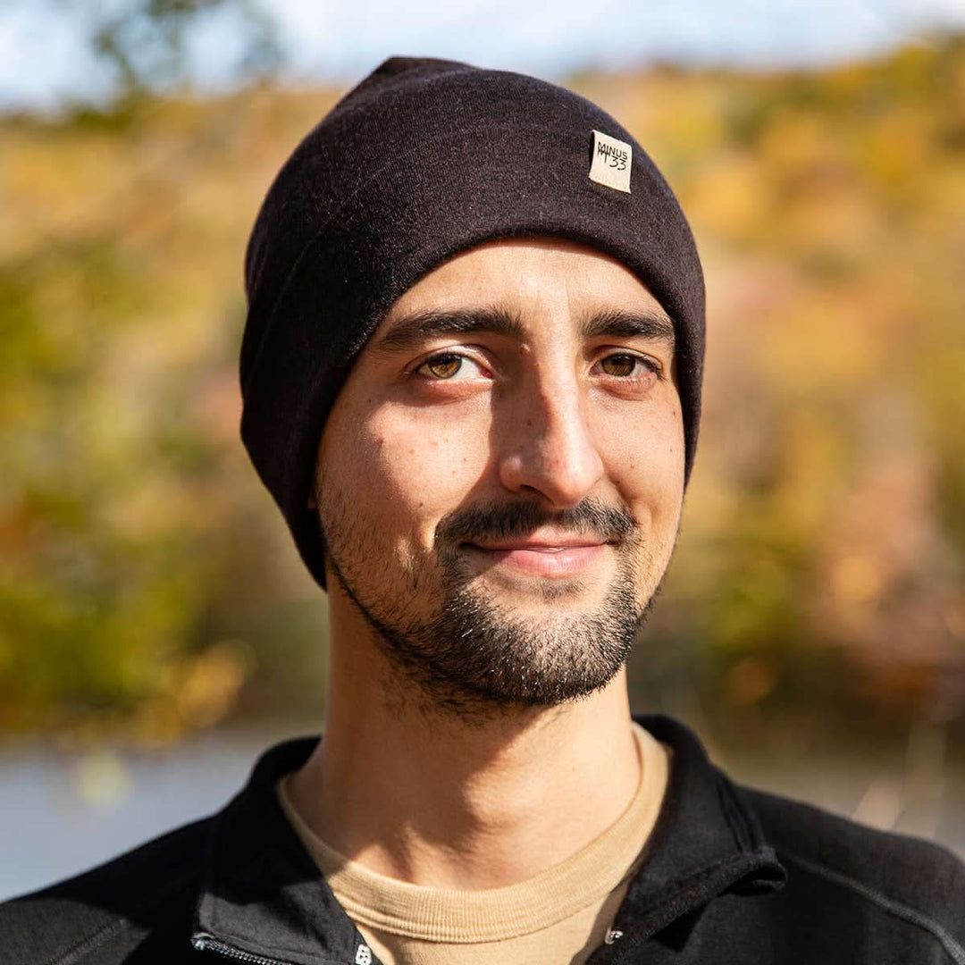 A man models the lightweight, double-layered, hundred percent, super soft merino wool beanie perfect for fall, winter, and spring. This hat is perfect for a hike up the mountain or a walk around the block!
