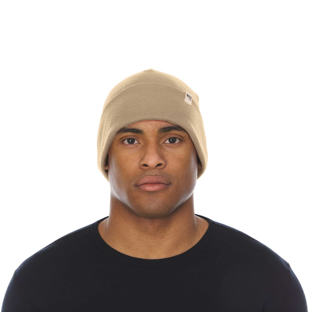 A man models the lightweight, double-layered, hundred percent, super soft merino wool beanie perfect for fall, winter, and spring. This hat is perfect for a hike up the mountain or a walk around the block!

