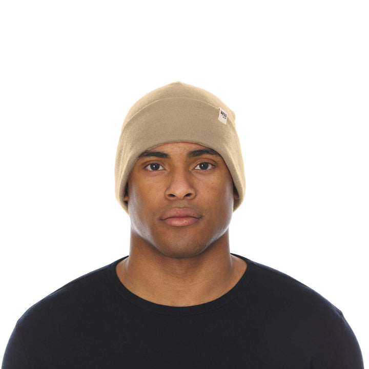 A man models the lightweight, double-layered, hundred percent, super soft merino wool beanie perfect for fall, winter, and spring. This hat is perfect for a hike up the mountain or a walk around the block!
