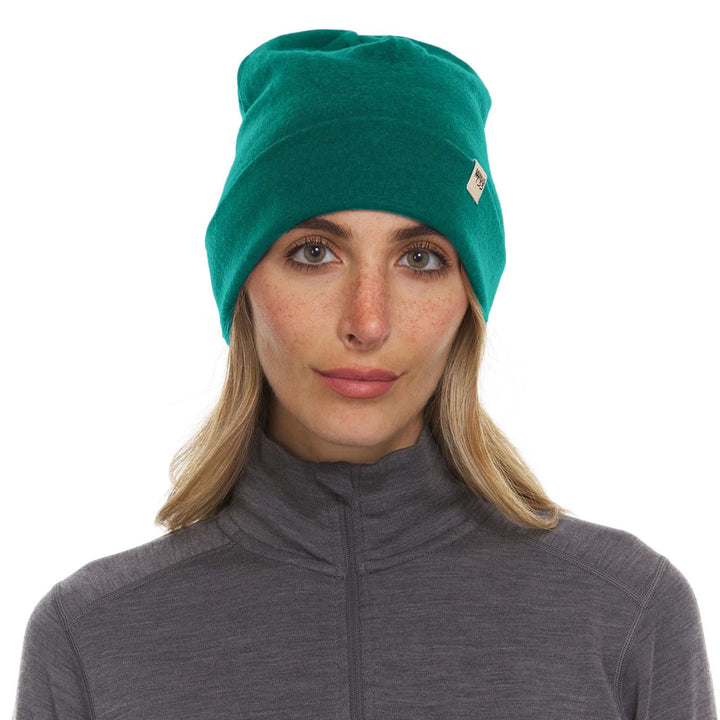 A woman models a lightweight, double-layered, hundred percent, super soft merino wool beanie perfect for fall, winter, and spring. This hat is perfect for a hike up the mountain or a walk around the block!
