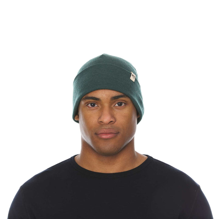 A man models the lightweight, double-layered, hundred percent, super soft merino wool beanie perfect for fall, winter, and spring. This hat is perfect for a hike up the mountain or a walk around the block, front view 