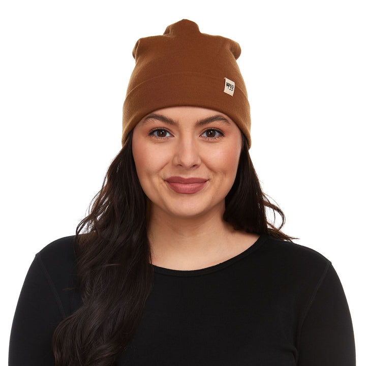 Front view of a model wearing a golden brown lightweight double-layer 100% merino wool beanie 