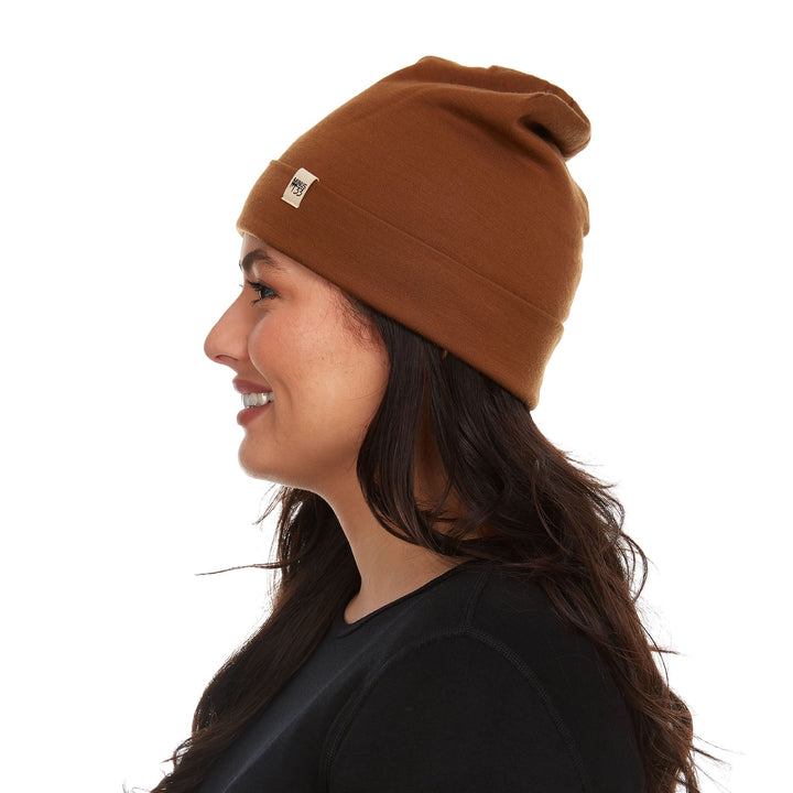 A woman models a lightweight, double-layered, hundred percent, super soft merino wool beanie perfect for fall, winter, and spring. This hat is perfect for a hike up the mountain or a walk around the block!

