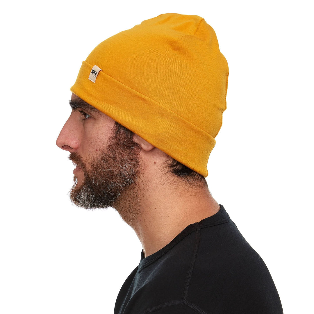 A man models the lightweight, double-layered, hundred percent, super soft merino wool beanie perfect for fall, winter, and spring. This hat is perfect for a hike up the mountain or a walk around the block!
