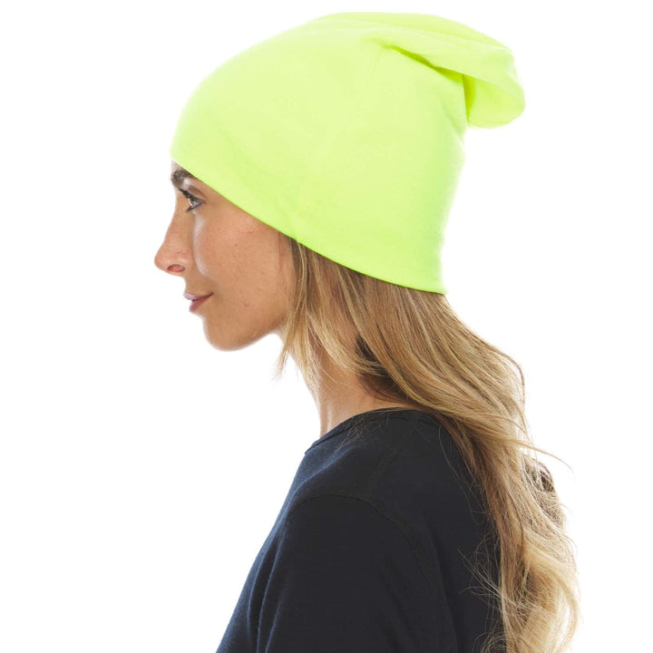 A woman models a lightweight, double-layered, hundred percent, super soft merino wool beanie perfect for fall, winter, and spring. This hat is perfect for a hike up the mountain or a walk around the block, right-facing side view 