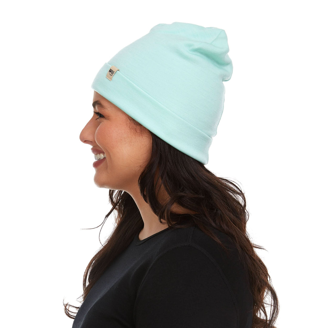A woman models a lightweight, double-layered, hundred percent, super soft merino wool beanie perfect for fall, winter, and spring. This hat is perfect for a hike up the mountain or a walk around the block!

