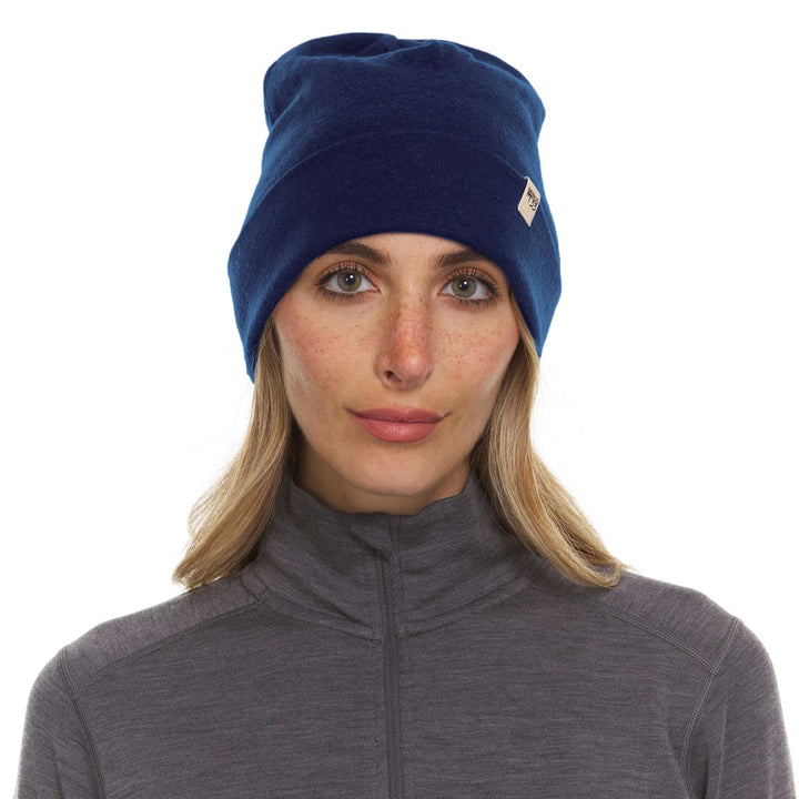 A woman models the lightweight, double-layered, hundred percent, super soft merino wool beanie perfect for fall, winter, and spring. This hat is perfect for a hike up the mountain or a walk around the block!
