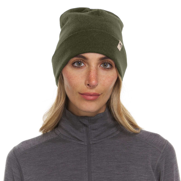 A woman models the lightweight, double-layered, hundred percent, super soft merino wool beanie perfect for fall, winter, and spring. This hat is perfect for a hike up the mountain or a walk around the block!
