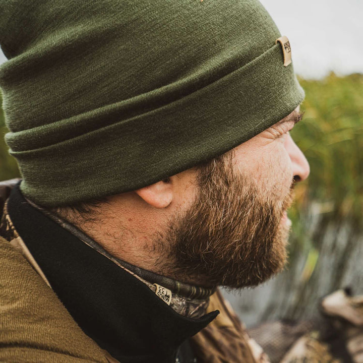 A man models the lightweight, double-layered, hundred percent, super soft merino wool beanie perfect for fall, winter, and spring. This hat is perfect for a hike up the mountain or a walk around the block!
