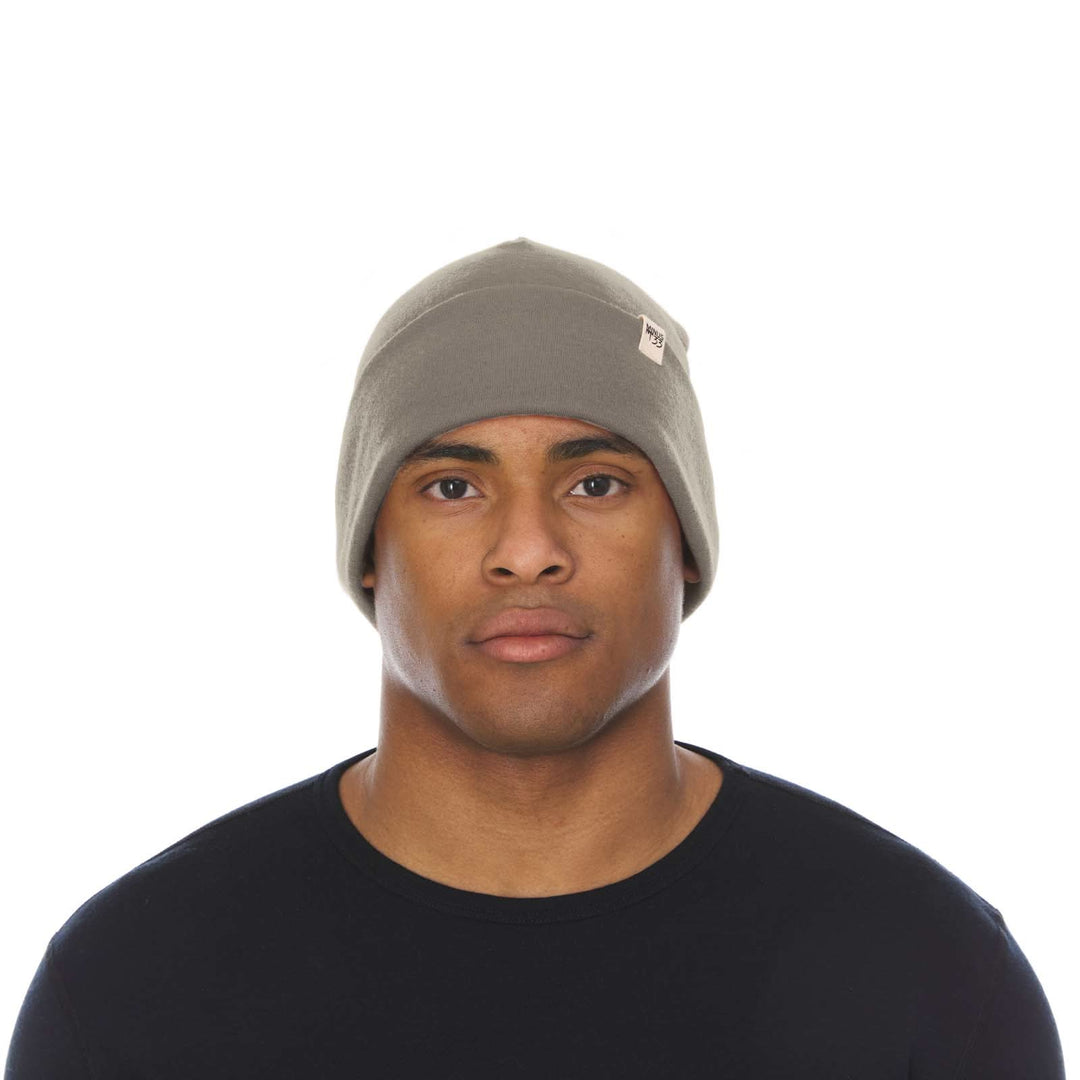 A man models the lightweight, double-layered, hundred percent, super soft merino wool beanie perfect for fall, winter, and spring. This hat is perfect for a hike up the mountain or a walk around the block!
