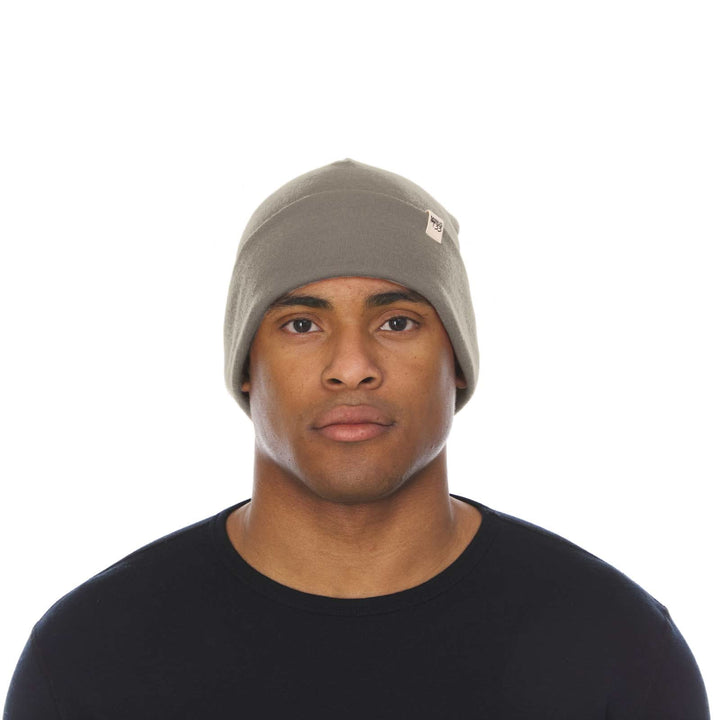 A man models the lightweight, double-layered, hundred percent, super soft merino wool beanie perfect for fall, winter, and spring. This hat is perfect for a hike up the mountain or a walk around the block!
