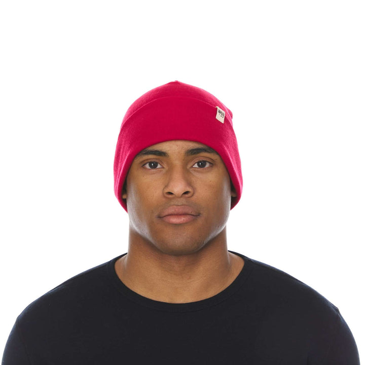 A man models a lightweight, double-layered, hundred percent, super soft merino wool beanie perfect for fall, winter, and spring. This hat is perfect for a hike up the mountain or a walk around the block!
