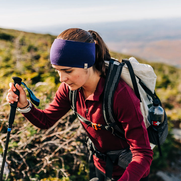Minus33 Merino Wool Clothing Midweight Wool Reversible Headband, front three-quarter view outdoors with hands on hips