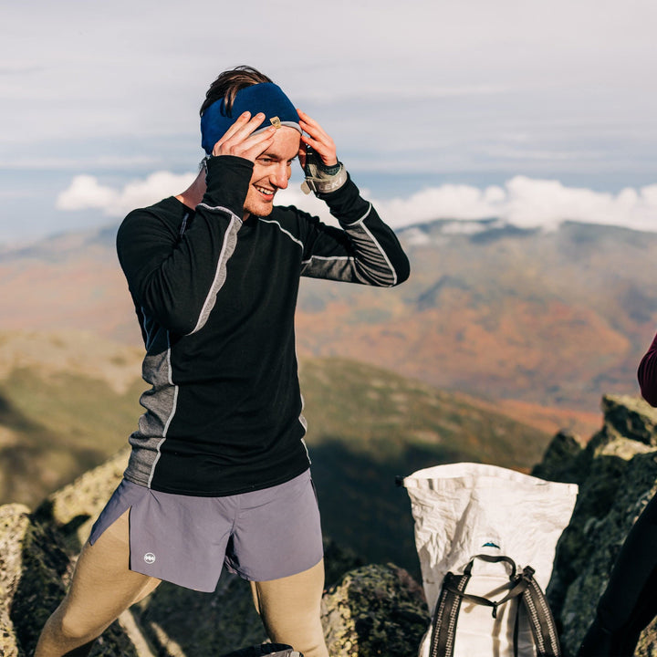 man hiking in the fall wearing the updated midweight woolverino crew neck long sleeve shirt