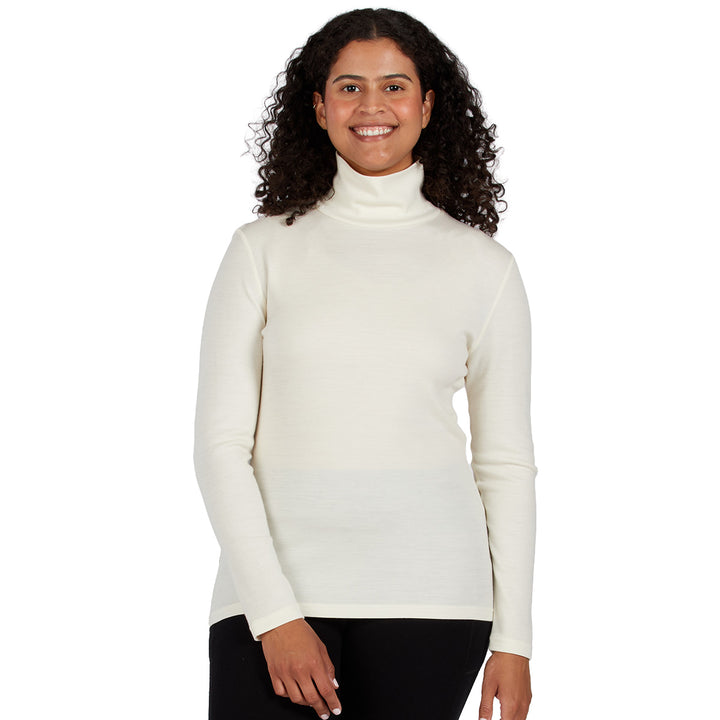 a cream-colored ribbed turtleneck sweater and black pants, merino wool 