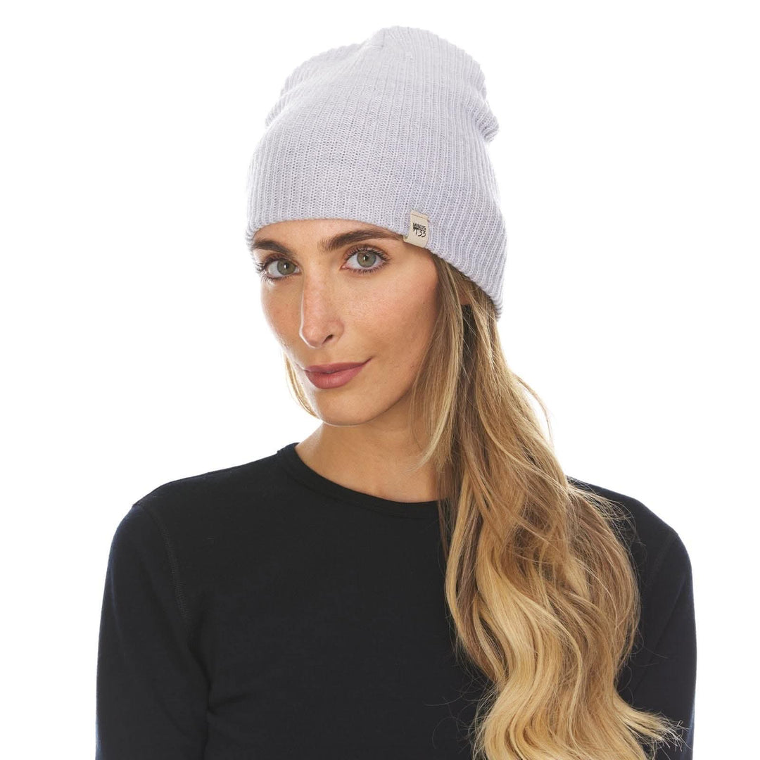 A woman models the midweight hundred percent merino wool beanie 