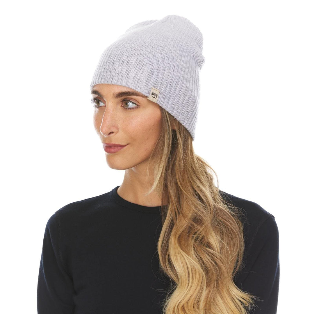 A woman models the midweight hundred percent merino wool beanie 