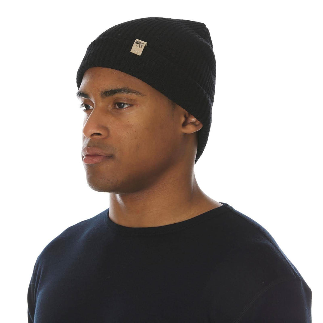 A man models the midweight hundred percent merino wool beanie 