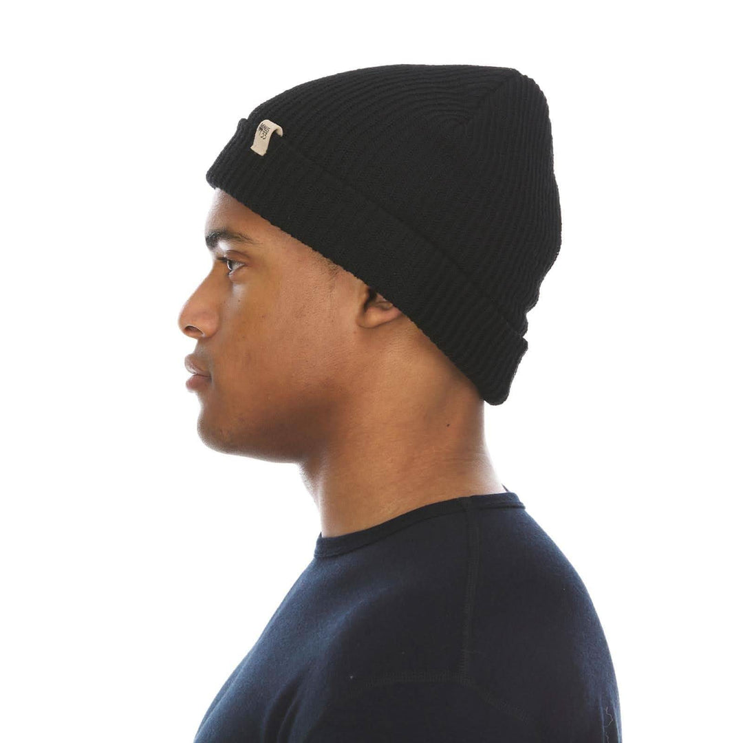 A man models the midweight hundred percent merino wool beanie 
