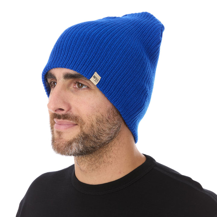 A man models the midweight hundred percent merino wool beanie 