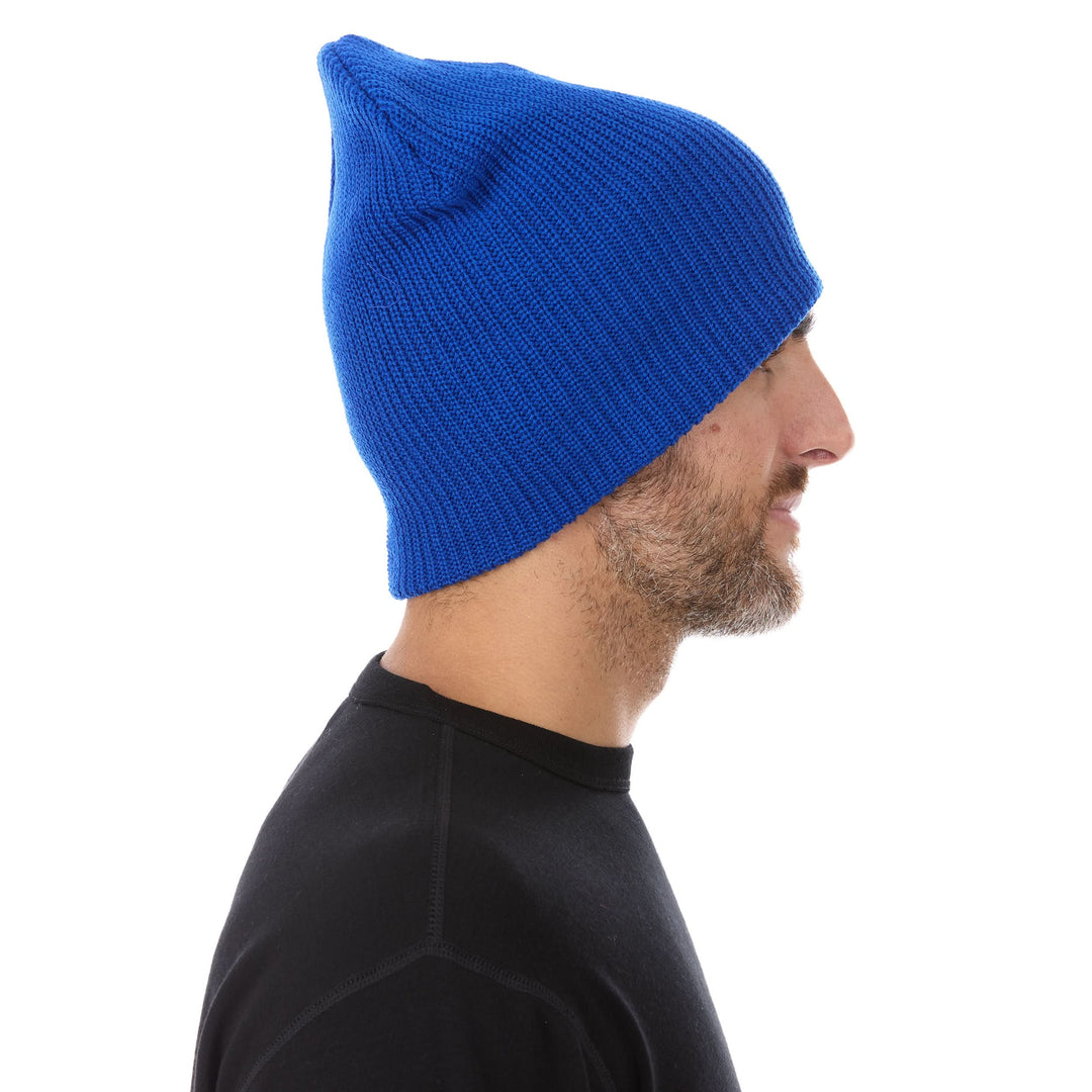 A man models the midweight hundred percent merino wool beanie, right-facing side profile 