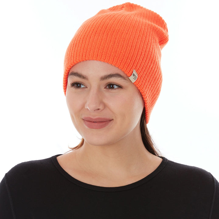 A woman models the midweight hundred percent merino wool beanie, front three-quarter view 
