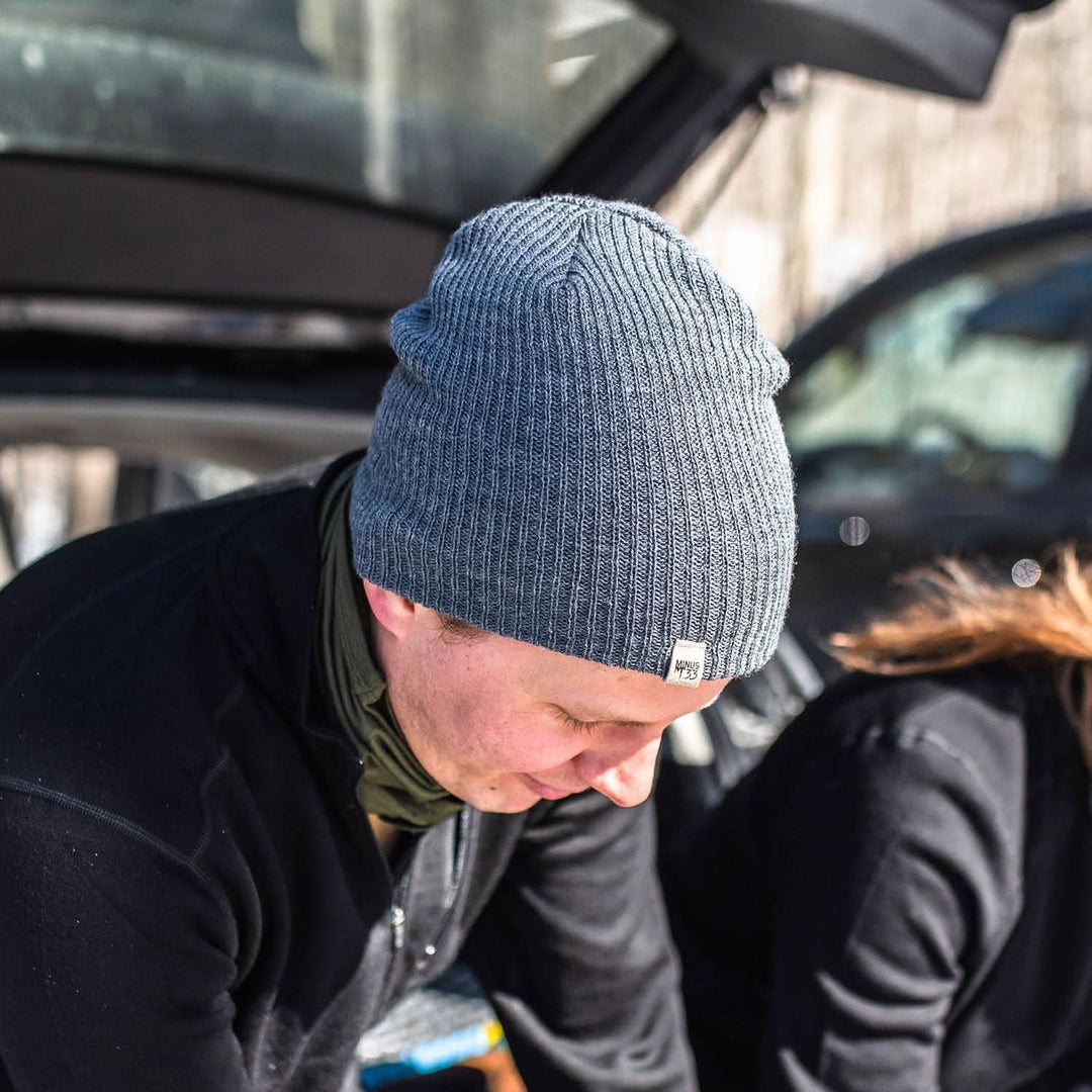 A man models the midweight hundred percent merino wool beanie 