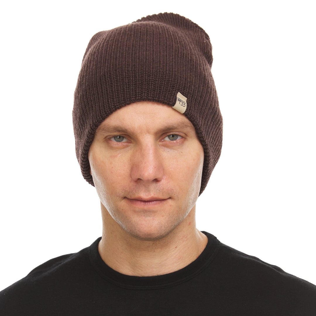 Front three-quarter view of a male model wearing a dark brown midweight merino wool beanie 