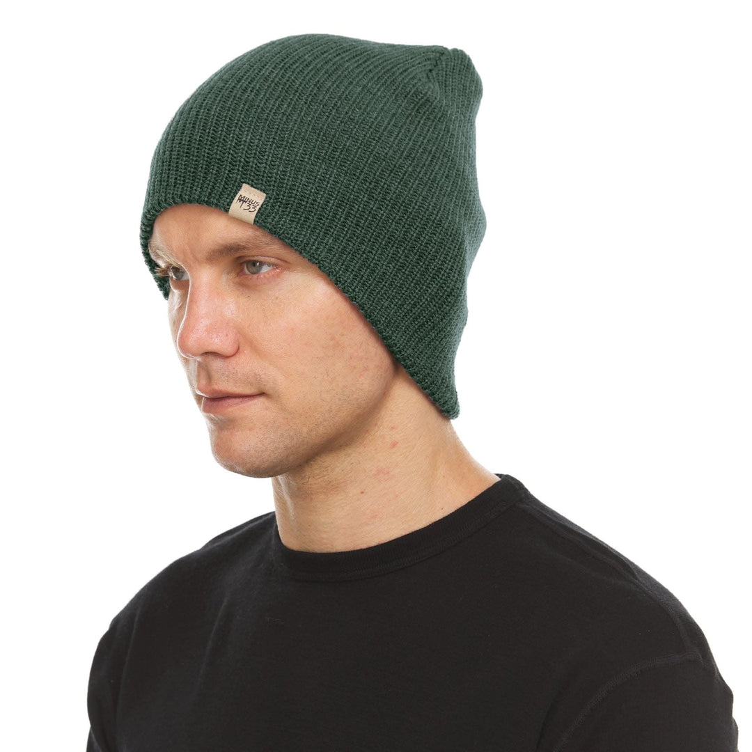A man models the midweight hundred percent merino wool beanie 