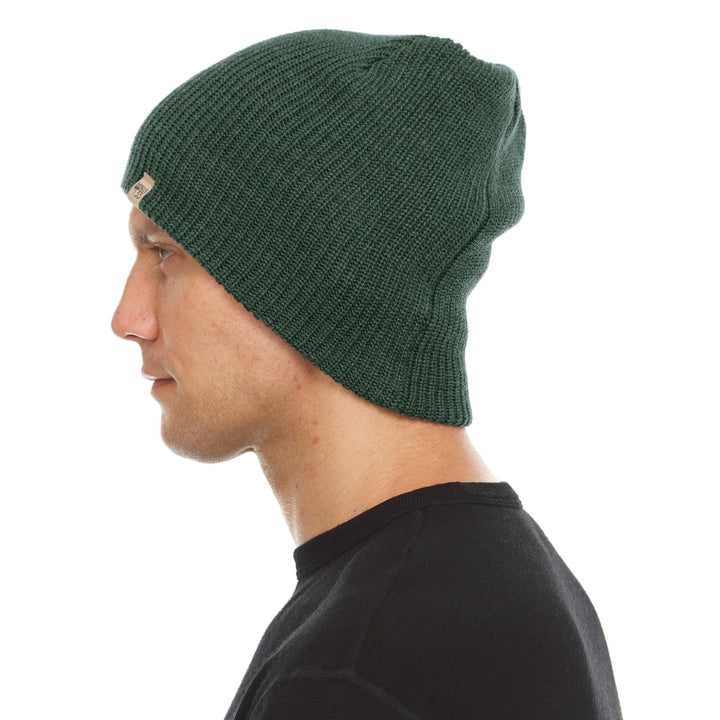 A man models the midweight hundred percent merino wool beanie 
