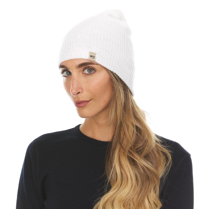 A woman models the midweight hundred percent merino wool beanie 