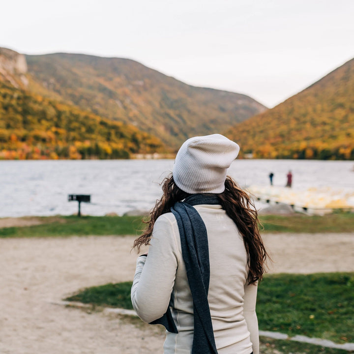 A woman models the midweight hundred percent merino wool beanie 