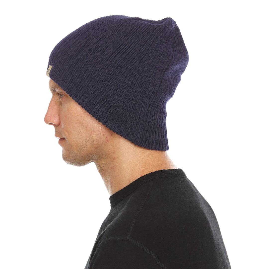 A man models the midweight hundred percent merino wool beanie 