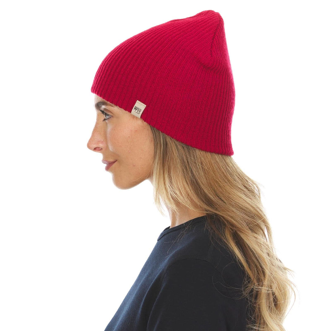 A woman models the midweight hundred percent merino wool beanie, right-facing side view 