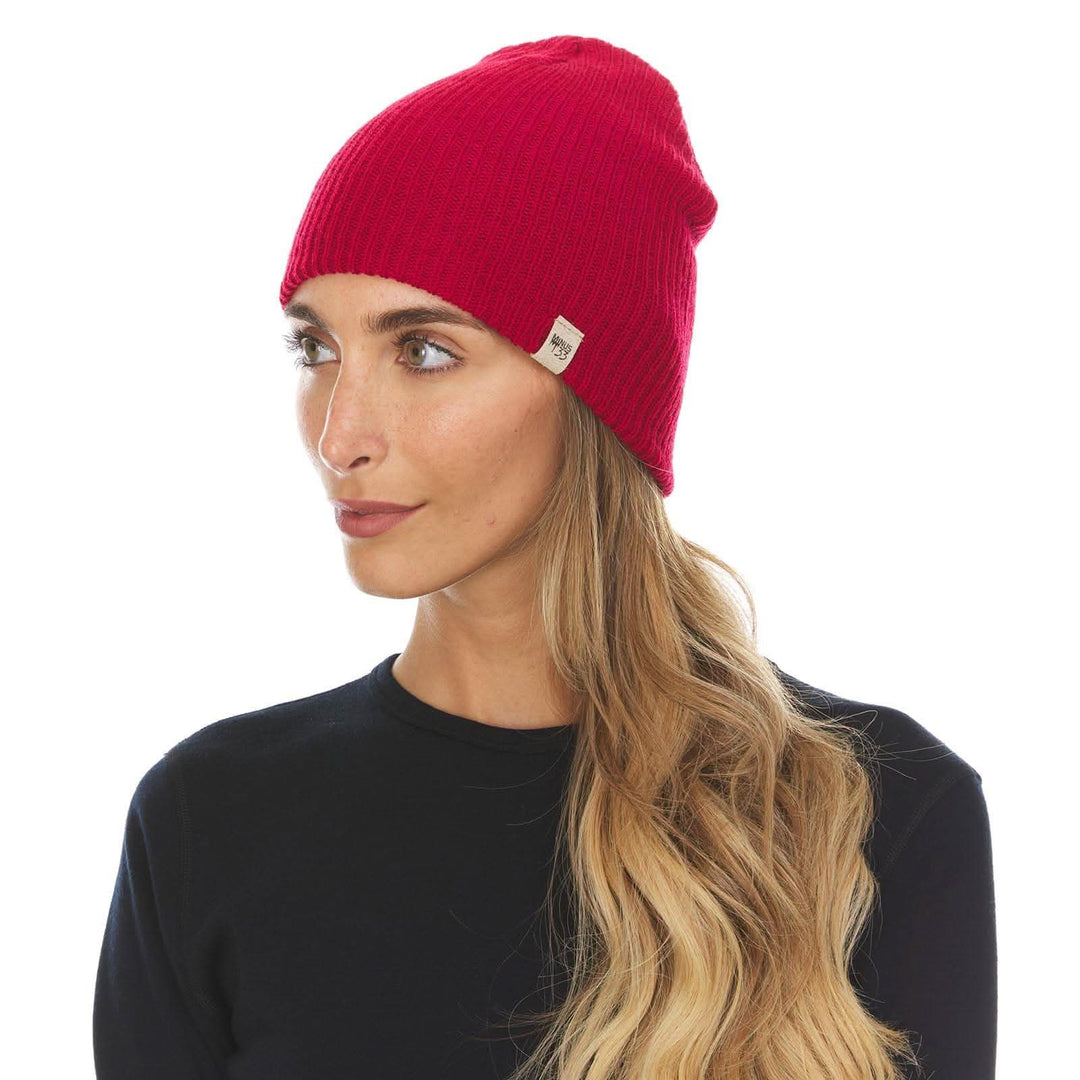 A woman models the midweight hundred percent merino wool beanie 