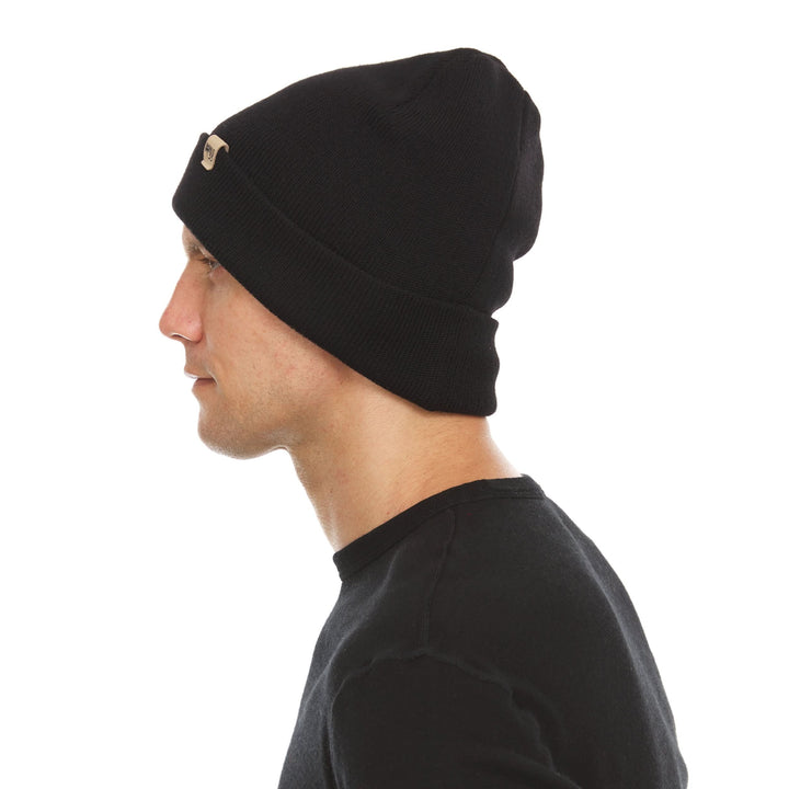 A man models the midweight double-layered merino wool beanie, right-facing side view 