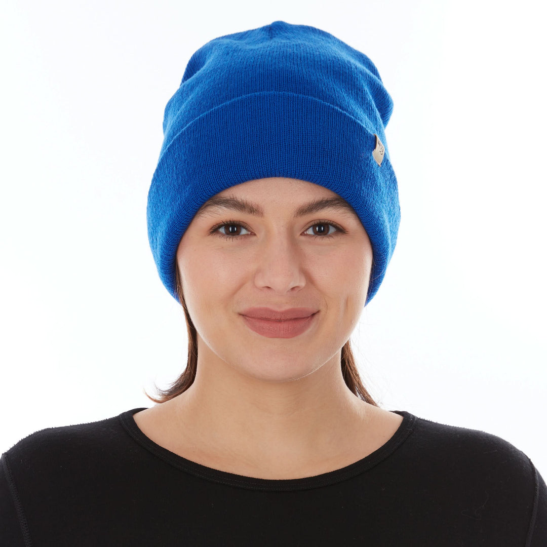 Head-and-shoulders front view of a female model wearing a royal blue midweight double-layer 100% merino wool beanie 