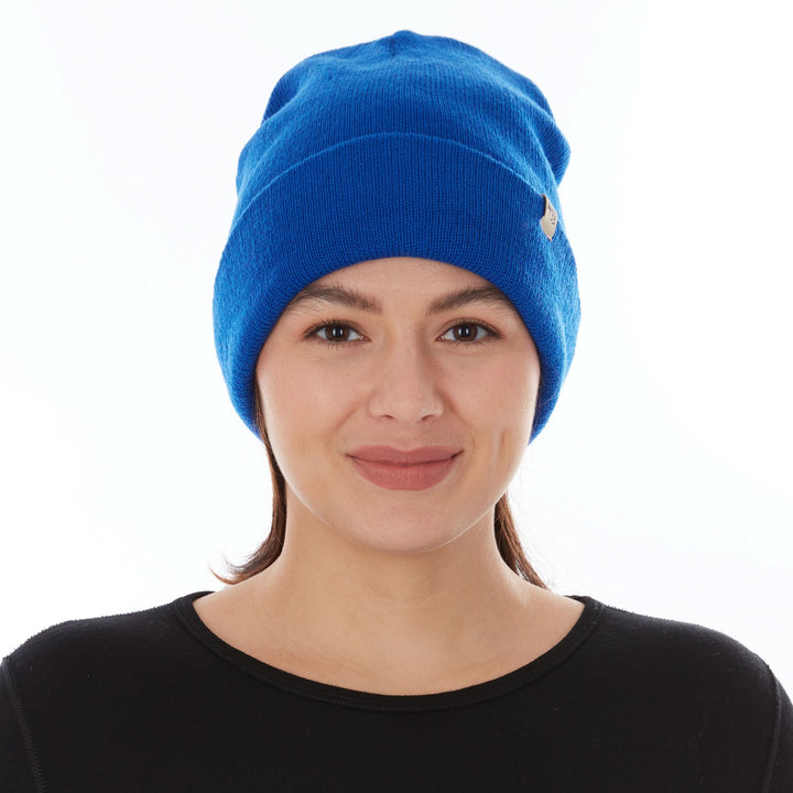 Head-and-shoulders front view of a female model wearing a royal blue midweight double-layer 100% merino wool beanie 