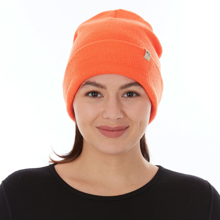 Front view of a female model wearing a blaze orange midweight double-layer 100% merino wool beanie 