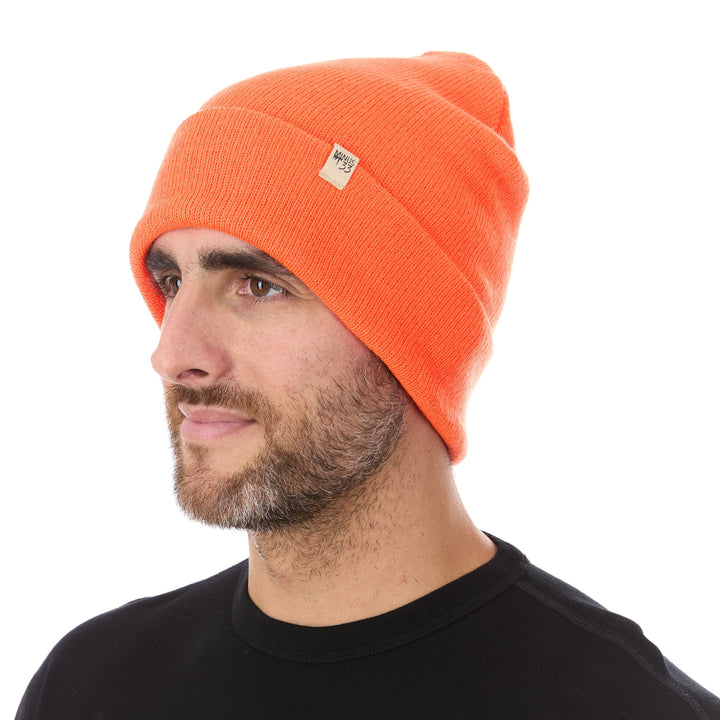 A man models the midweight, double-layered, hundred percent, super soft merino wool beanie that keeps you warm, but won&