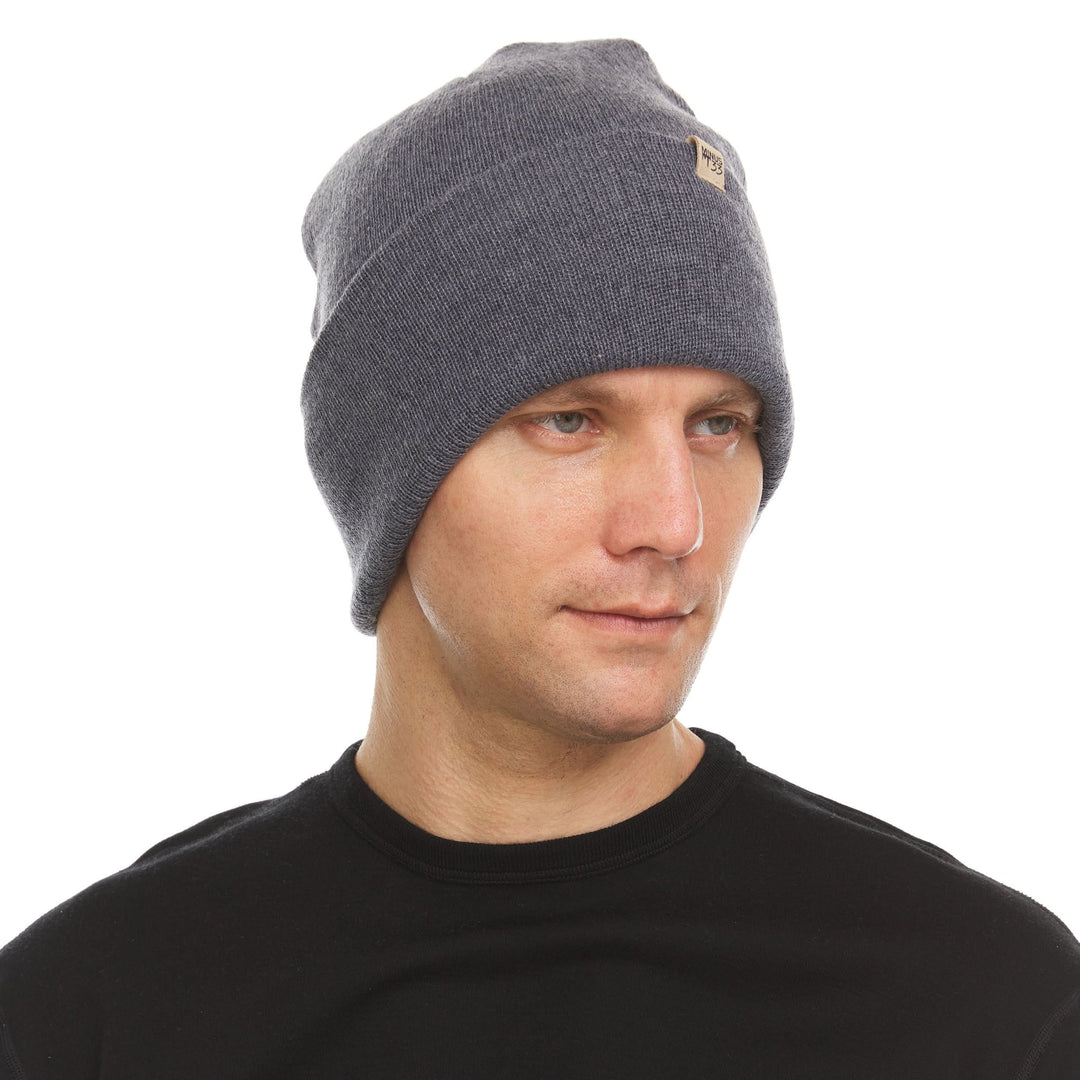 A man models the midweight double-layered merino wool beanie, front three-quarter view 