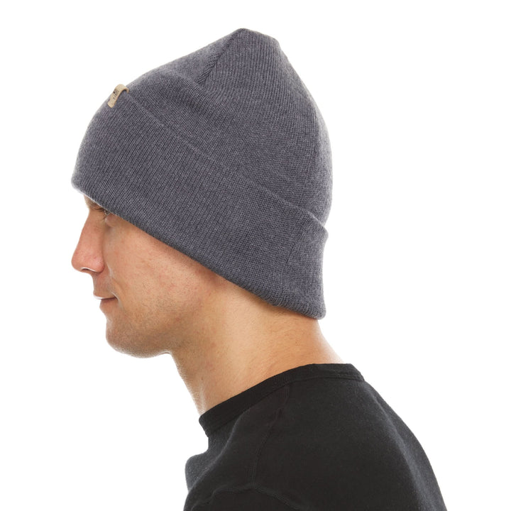 A man models the midweight double-layered merino wool beanie, right-facing side view 