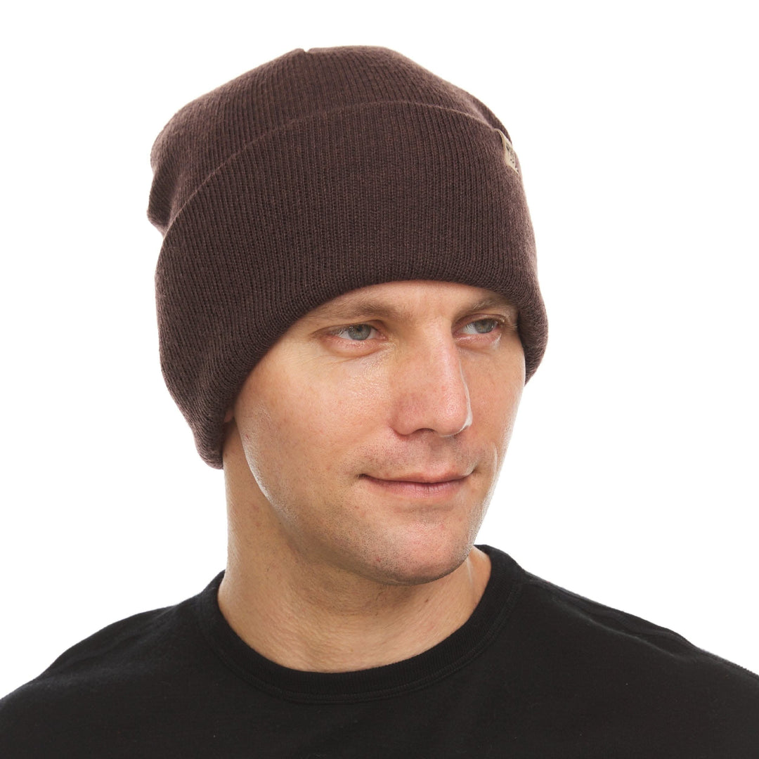 A man models the midweight, double-layered, hundred percent, super soft merino wool beanie that keeps you warm, but won&
