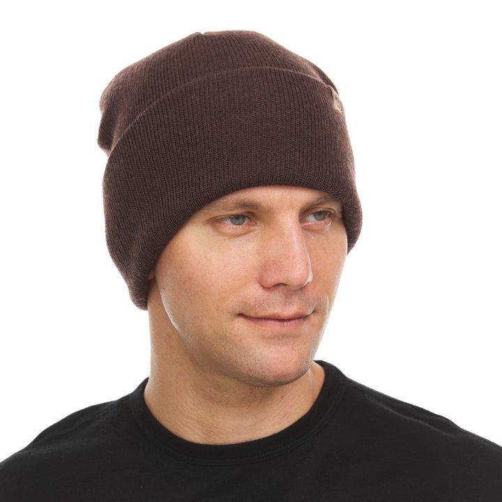 A man models the midweight, double-layered, hundred percent, super soft merino wool beanie that keeps you warm, but won&