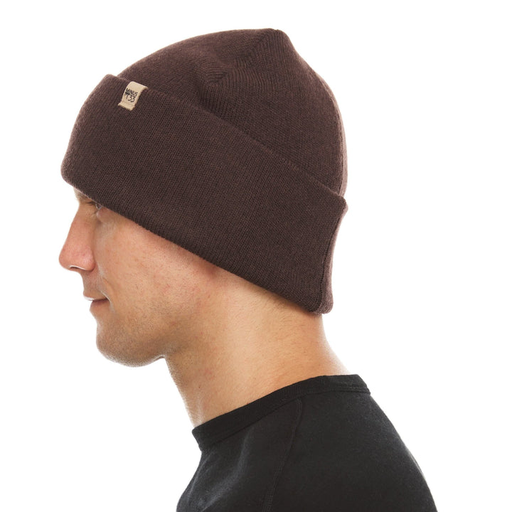 A man models the midweight, double-layered, hundred percent, super soft merino wool beanie that keeps you warm, but won&