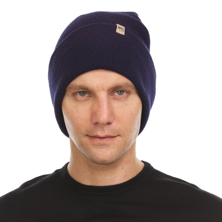 A man models the midweight, double-layered, hundred percent, super soft merino wool beanie that keeps you warm, but won&