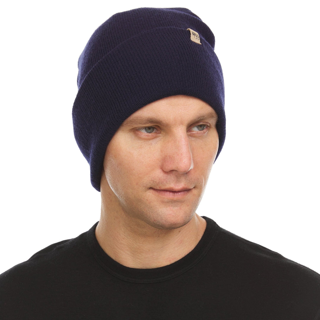 A man models the midweight, double-layered, hundred percent, super soft merino wool beanie that keeps you warm, but won&