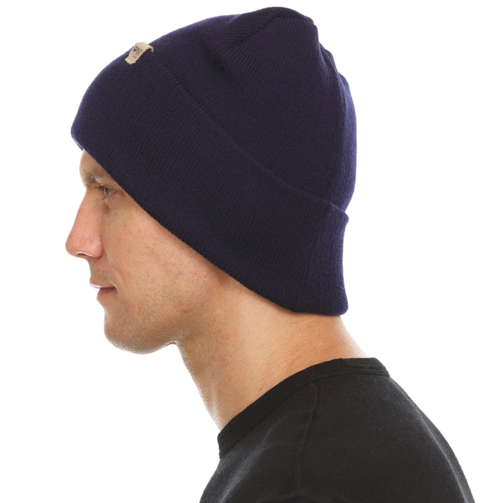 A man models the midweight, double-layered, hundred percent, super soft merino wool beanie that keeps you warm, but won&