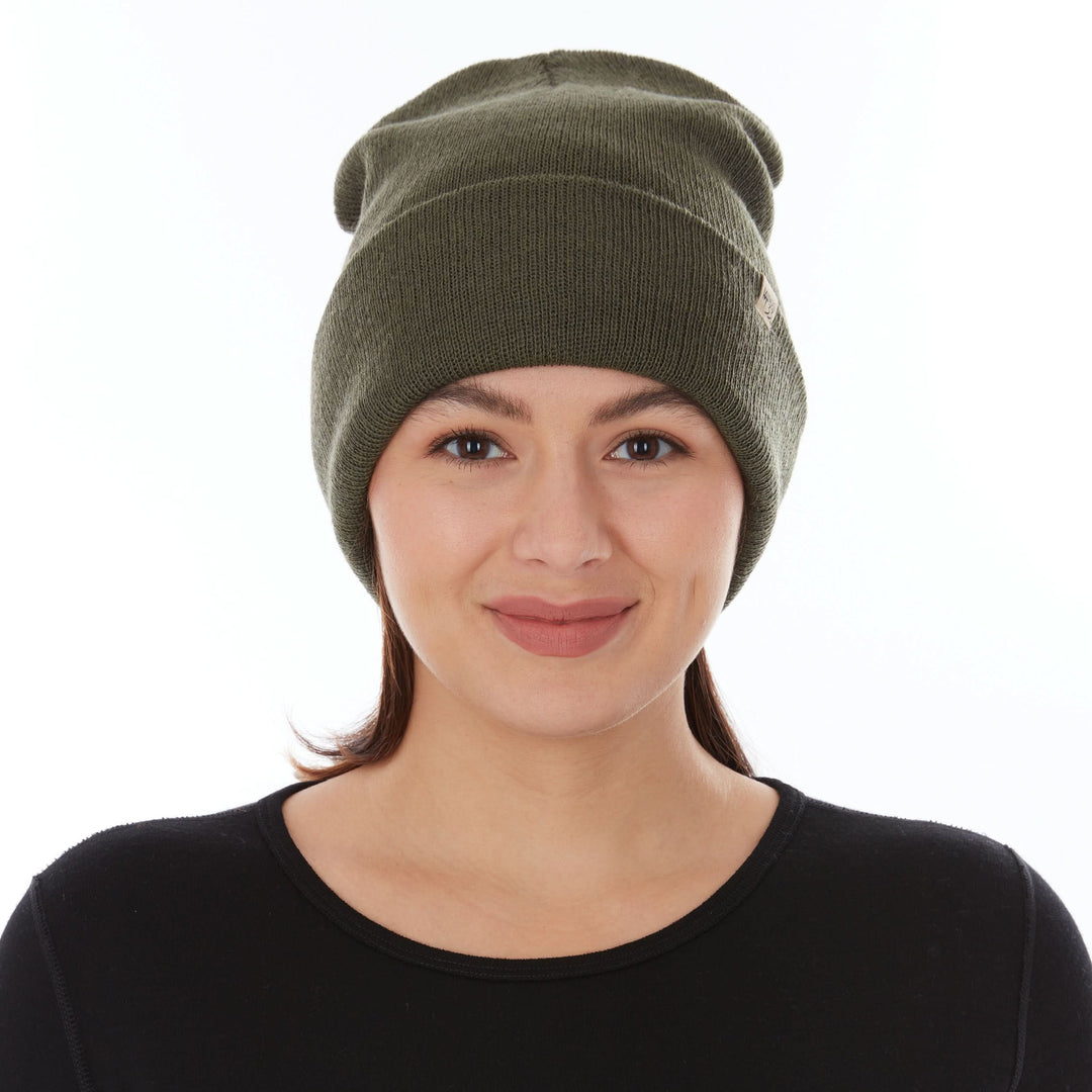 Front view of a female model wearing an olive drab green midweight double-layer 100% merino wool beanie 